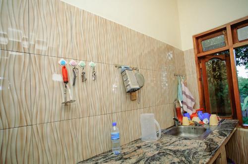 a kitchen with a sink and a counter with a sink at Panofu Homestay in Moshi