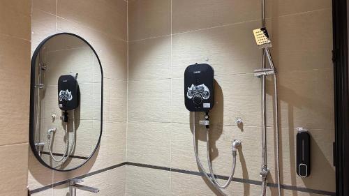 a bathroom with a shower and a mirror at sohho Hotel in Cukai
