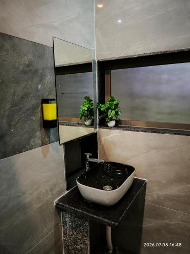 a bathroom with a sink and a mirror at Aeronest Villa "your new escape" in Udaipur