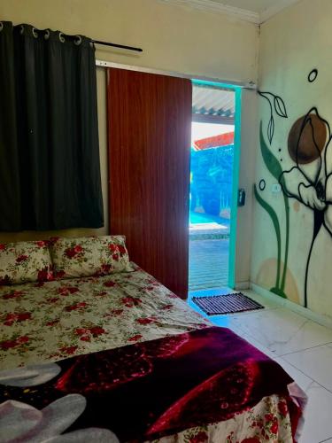 a bedroom with a bed and a sliding glass door at MT laser in São José da Coroa Grande