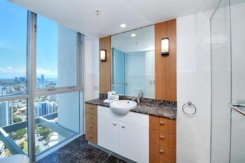 a bathroom with a sink and a mirror at Deluxe Chevron Renaissance in Gold Coast