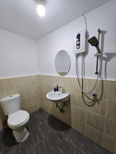a bathroom with a toilet and a sink at Wobbless Wonder Homestay in Bandar Seri Begawan