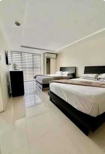 a bedroom with two beds and a window in it at Royal Estate in Portmore