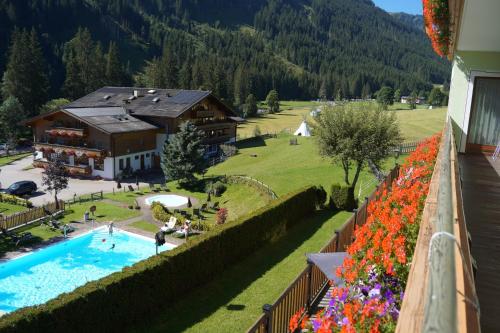 a view from a balcony of a resort with a swimming pool at Landhaus St Georg inklusive Jokercard in Saalbach-Hinterglemm