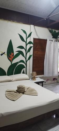 a bed with a hat sitting on top of it at Boca Tapada Inn in Boca Tapada