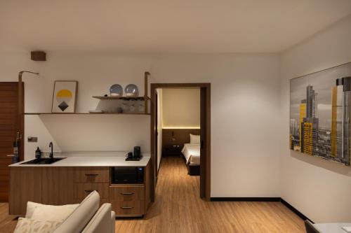 a room with a kitchen and a living room with a bed at WH Hotel 310 in Phnom Penh