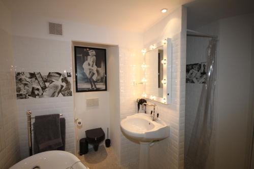 a white bathroom with a sink and a toilet at From Hollywood to Bollywood 2 Bedrooms 2 Bathrooms - 1 min from Croisette&Beach, 12 Min from the Palais in Cannes