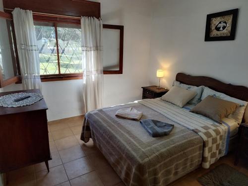 a bedroom with a bed with two pillows on it at Pinos del Virrey I in Valle Hermoso