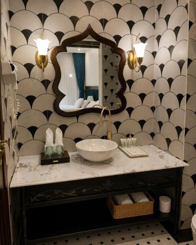 a bathroom with a sink and a mirror at Le Mont Yên Bái in Yên Bái
