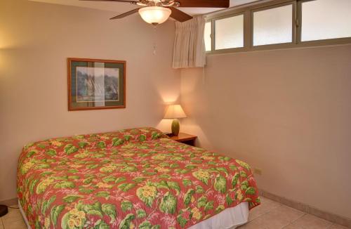 a bedroom with a bed and a ceiling fan at Hale Kai O'Kihei 219 in Kihei