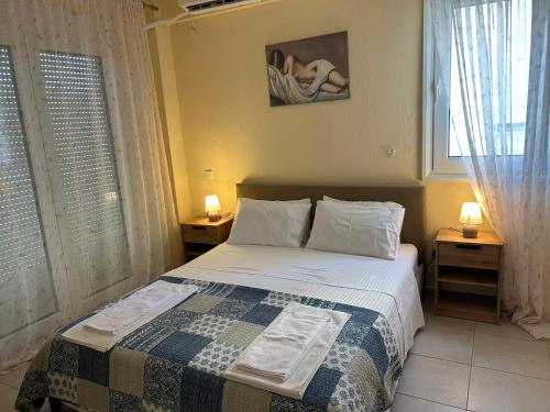 a bedroom with a bed with a quilt on it at Iliana House in Neoi Epivates