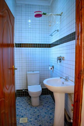 a bathroom with a toilet and a sink at theSuperblane Resort in Sagana