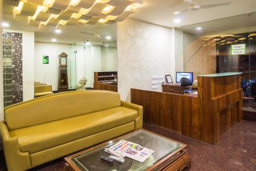 a store with a yellow couch and a table at Itsy By Treebo - Arastu Inn in Hyderabad