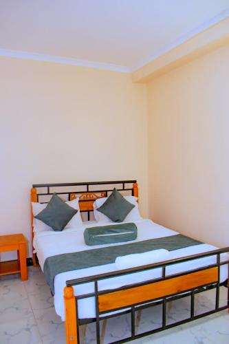a bedroom with a bed in a room at theSuperblane Resort in Sagana