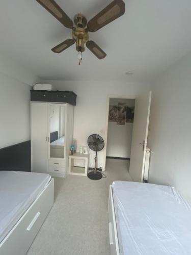 a room with two beds and a ceiling fan at residence st marguerite in Antibes