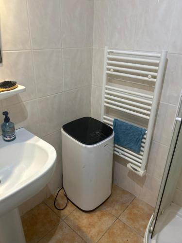 a bathroom with a sink and a trash can at residence st marguerite in Antibes