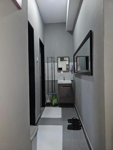 a bathroom with a sink and a mirror at B&B By JumStay in Sepang