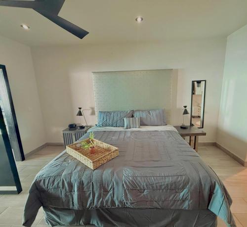 a bedroom with a large bed with a basket on it at Sol y mar in Rosarito Beach