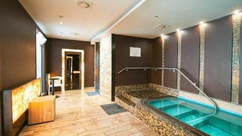 a bathroom with a hot tub in the middle at Zalakaros Wellness Oázis Apt, nappali, 1háló, 4 fő in Zalakaros