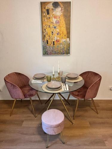 a dining room table with two chairs and a painting at Dolce Risveglio in Monticello