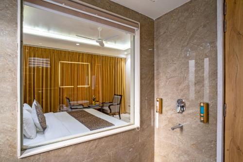 a bedroom with a large window in a bathroom at The Delhi Star Hotel near Connaught Place- New Delhi in New Delhi