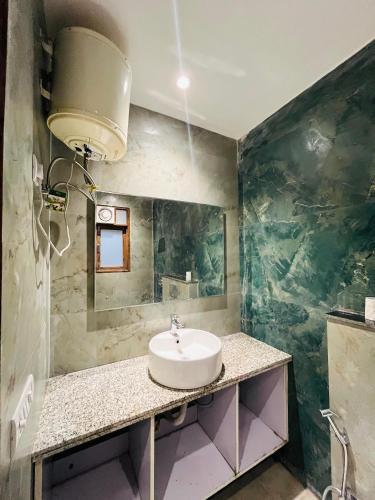 a bathroom with a sink and a large mirror at Hotel fabulous - Malviya Nagar in New Delhi