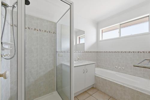 a bathroom with a shower and a sink at Serrell by the Sea in Inverloch