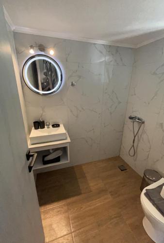 a bathroom with a sink and a mirror on the wall at O' Kipos in Mythimna