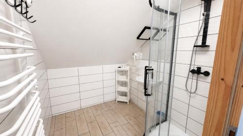 a bathroom with a shower with a glass door at Hotel Ukiel Wellness & SPA in Olsztyn