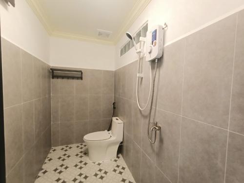 a bathroom with a toilet and a shower at Vital Point Kampot in Kampot
