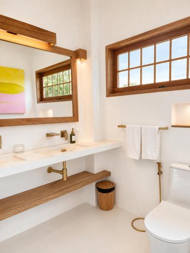 a bathroom with a sink and a toilet at Haku - Japandi Village in General Luna