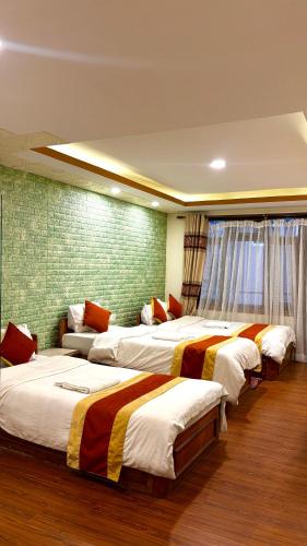 a group of four beds in a room at Kathmandu Peace Guesthouse in Kathmandu