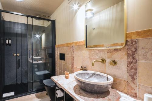 a bathroom with a large sink and a shower at Passeio Sintra Collection in Sintra