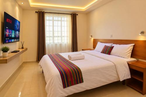 a bedroom with a large bed and a television at COMFORT E SUITES in Nairobi