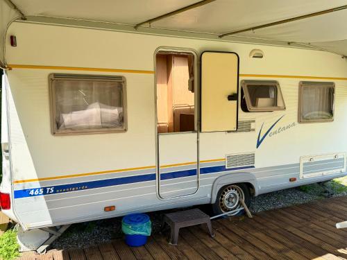 an rv is parked with its door open at Campinplatz Margarethenruh in Nordstrand