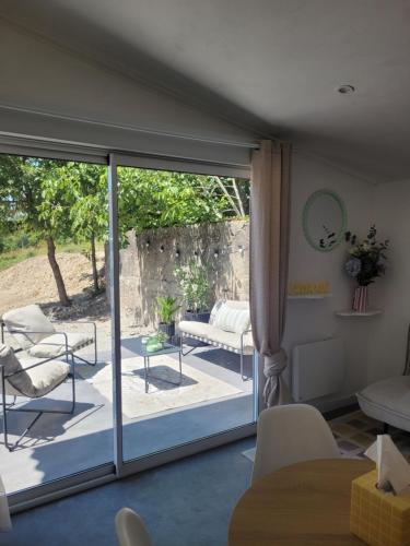 a living room with a sliding glass door at Le cocon du pas de Lauzens in Aouste-sur-Sye