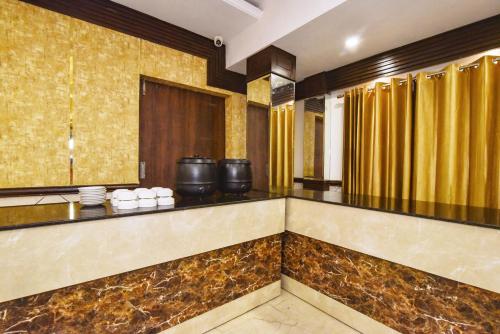 a hotel lobby with gold walls and a bar at Pineberry Hotels - Near Golden Temple in Amritsar