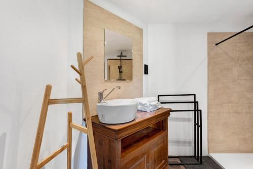 a bathroom with a sink and a mirror on a counter at les Iris in Pont-Saint-Esprit