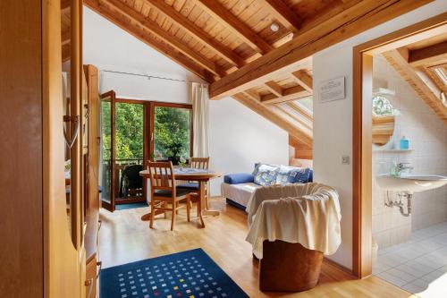 a living room with a table and a couch at Ferienwohnungen Im Försterhaus in Lonsee