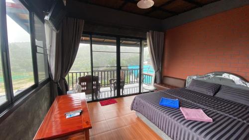 a bedroom with a bed and a balcony at Love Loft Homestay in Ban Pilok Khi