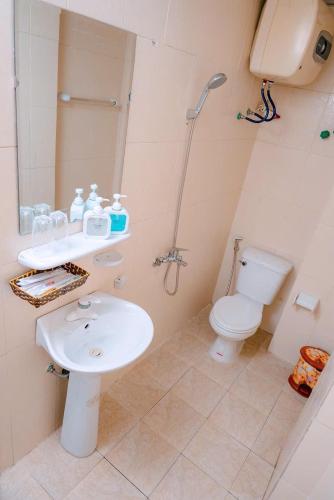 a bathroom with a toilet and a sink and a shower at SunWay hotel in Cat Ba
