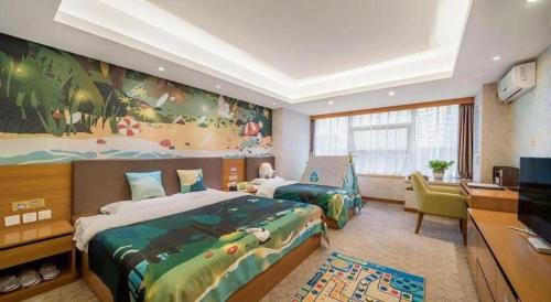 a bedroom with two beds and a desk and a television at Oak Chateau in Jinzhou