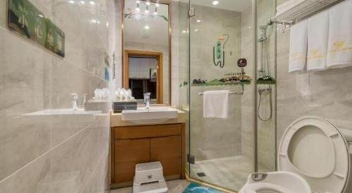 a bathroom with a shower and a toilet and a sink at Oak Chateau in Jinzhou