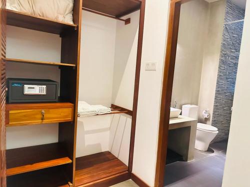 a small bathroom with a toilet and a microwave at Golden Pearl Tangalle Beach in Tangalle