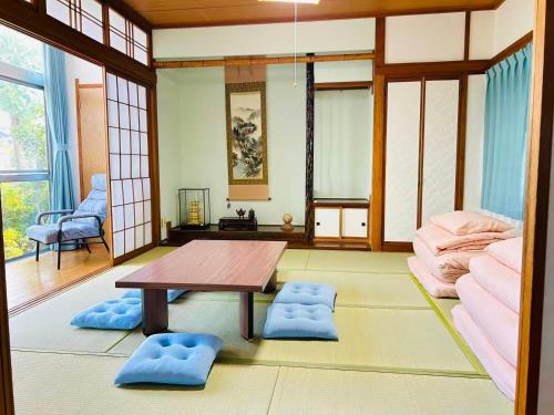 a living room with a table and a couch at 一棟貸切民宿Saisai 3部屋 in Sakai