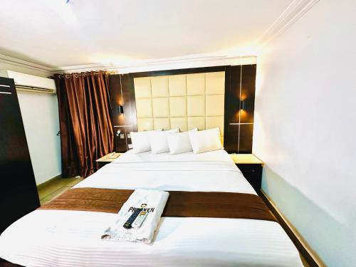 a hotel room with two beds and a window at Presken Hotel Reliance, Allen, Ikeja, Lagos in Ikeja