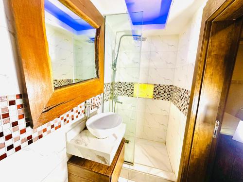 a bathroom with a toilet and a shower at Presken Hotel Reliance, Allen, Ikeja, Lagos in Ikeja