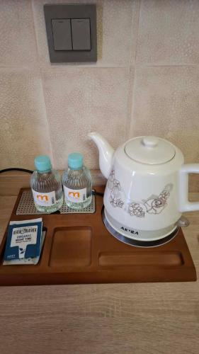 a tea set on a wooden table with a tea kettle at Crystal House Hotel in Buyant-Uhaa