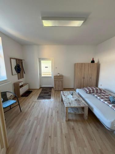 a bedroom with a bed and a table in it at Centrum Brezno in Brezno