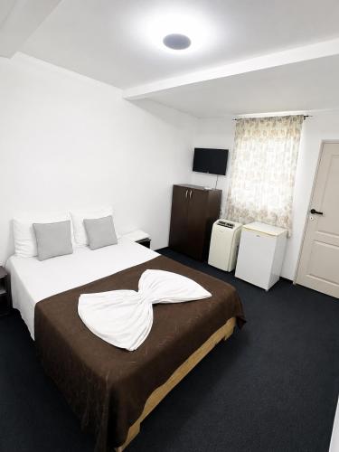 a hotel room with two beds and a window at Casute tip A costinesti in Costinesti